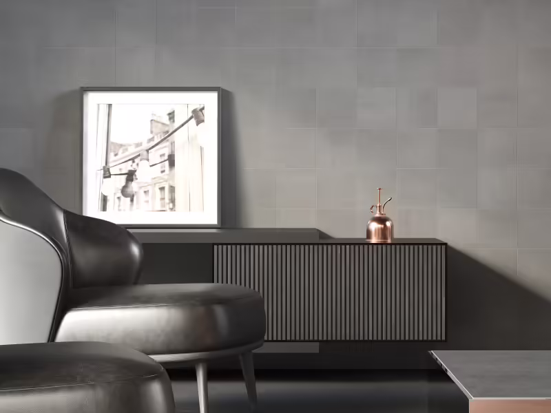Carrelage ciment gris pierre Mur de salon revêtu d'un carrelage ciment gris à effet béton authentique et texture minérale mate